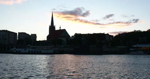 West Oder River and St. James Cathedral at Sunset in Szczecin Poland Zoom In Stock Footage 337586497