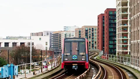 West Silvertown DLR Station capturing departing trains Stock Footage 297700796