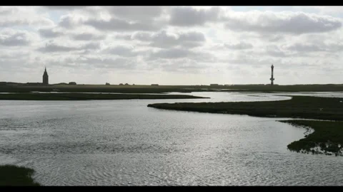 West tower and new lighthouse, back light, water, view from Inselbahn, Stock Footage 340926242