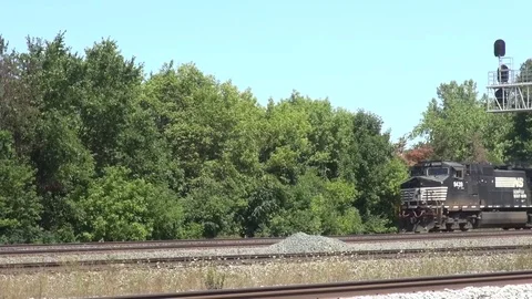 Westbound Intermodal freight train meets &amp; passes an Eastbound oil tanker train Stock Footage 81922511
