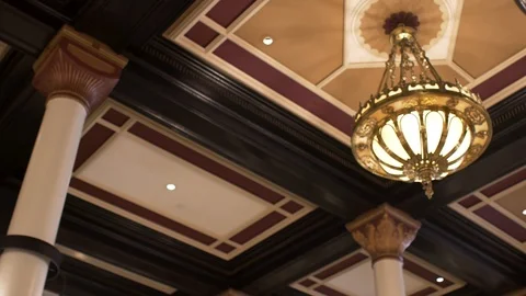 Western chandelier ceiling light at an upscale hotel Stock Footage 122861834