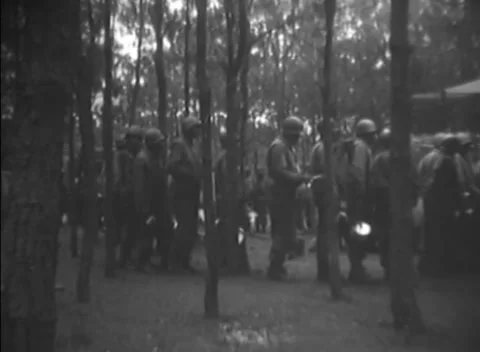 WESTERN EUROPE - 1944: Ration queue - Soldiers wait in woodland meal line Stock Footage 344487293