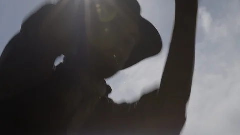 Western Man digging with pick and shovel - silhouette in the hot sun Stock-Footage 99757867