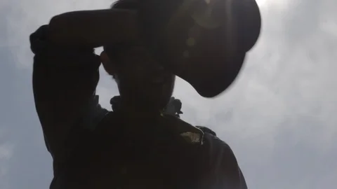 Western Man digging with pick wipes brow with hat in the hot sun Stock Footage 99758053