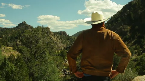 Western man looking at land cowboy hat west Stock Footage