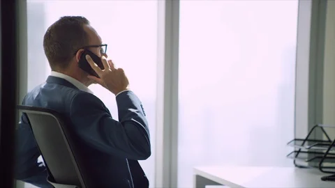 Western man talking on his mobile. Stock Footage 129399763