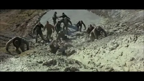 Western - Men slide down the hill through mud Stock Footage 284656051