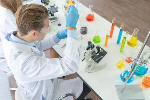 A western scientist man working on test tube to analysis and develop vaccine  Stock Photos