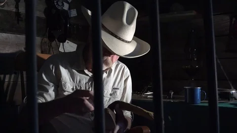 Western sheriff as seen from the jail cell, low light Stock Footage 92744942