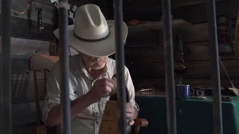 Western sheriff as seen from the jail cell wearing badge Stock Footage 92745663
