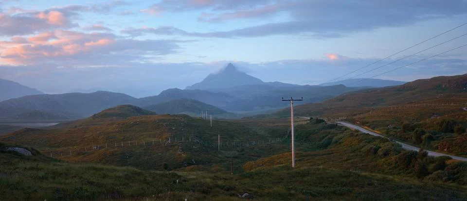 The western slope of Mount Ben Stack and the road through the valley at dawn Stock Photos