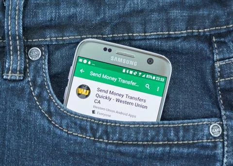Western Union mobile application on screen of Samsung Stock Photos