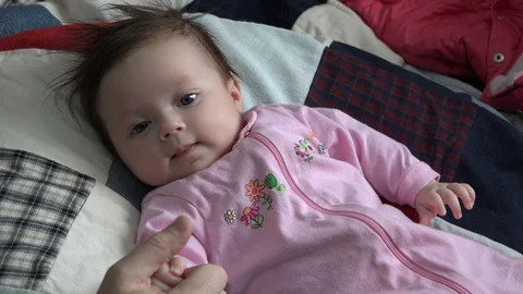 WESTMINSTER COLORADO-2015: Baby On A Patchwork Quilt Looking At Camera 動画素材 129349237