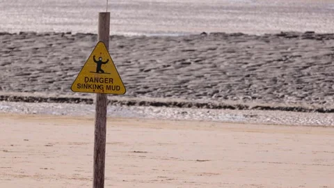 WESTON, UK - AUGUST 8, 2025 - Danger sinking mud sign indicating dangerous area Stock Footage 314804933