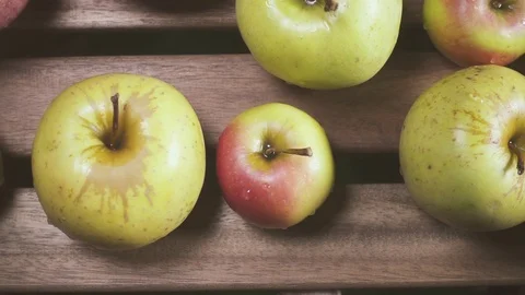 Wet apples on the table top view slow motion Stock Footage 88096740