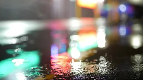 Wet Asphalt: Neon Reflections in Rain Video stock 339268325