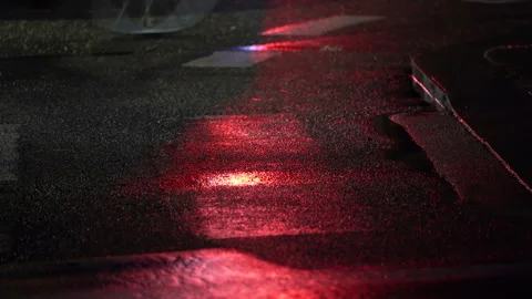 Wet asphalt at night with red light reflection on road. Stock Footage 335515429