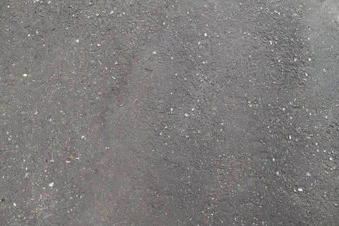 Wet asphalt texture, rough texture with cracks and dents Foto stock