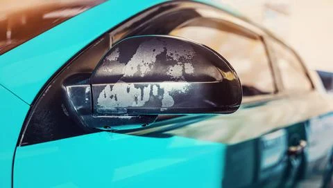 Wet black plastic side mirror of blue car washed in carwash, closeup detail Stock Photos