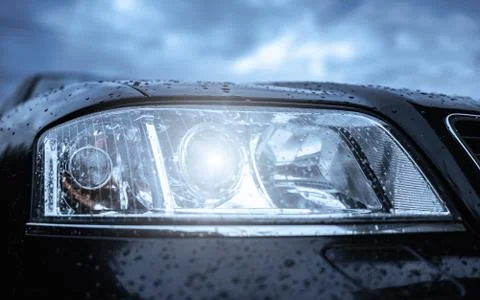 Wet car headlight. Stock Photos