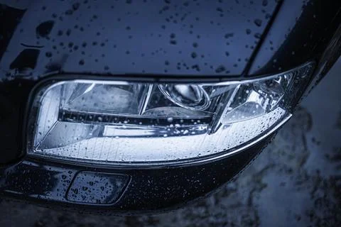 Wet car headlight. Stock Photos