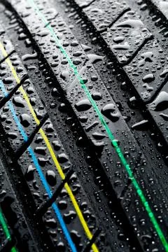 Wet car tire - thread pattern closeup Stock Photos