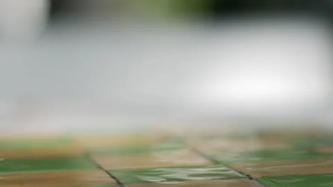 Wet Checkered Tile Floor with Shallow Focus and Blurred Bright Stock Footage 340606806