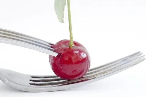 Wet cherry with two fork Stock Photos