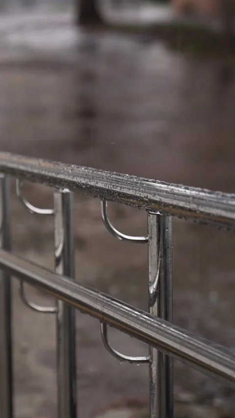 Wet chrome handrail. Metallic railing with rain droplets in storm Video stock 331933324