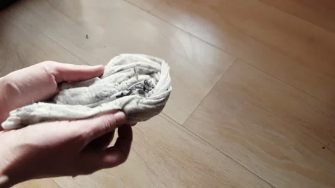 Wet cleaning of dirt and dust by the housekeeper's hands on the floor. Stock Footage 240959708