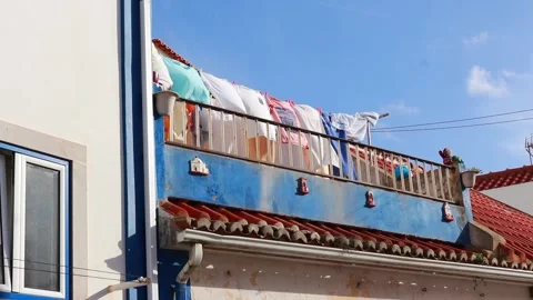 Wet clothes dry on a clothesline in the wind Stock Footage 254975762