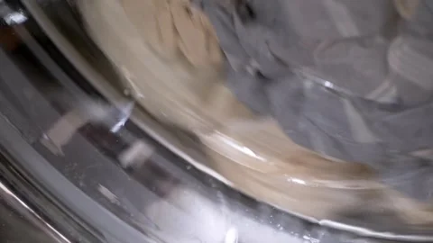 Wet Clothes Spinning Rapidly Inside Front Load Washing Machine Drum Video stock 338996512