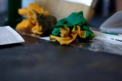 Wet colored rags on the dark surface Stock Photos