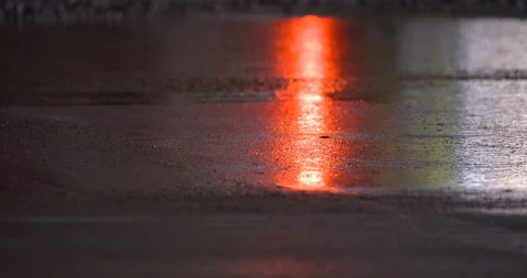 Wet concrete floor after leveling, shines in the light and reflects red light  Stock Footage 161990384