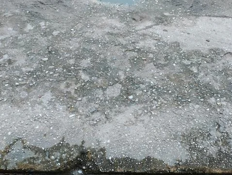 Wet Concrete Surface with Small Pebbles and Water Puddles Texture 写真素材