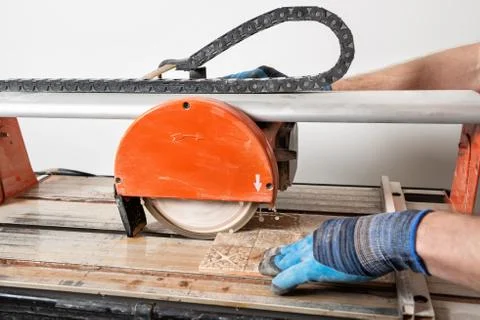 Wet cutting a ceramic tile. Stock Photos
