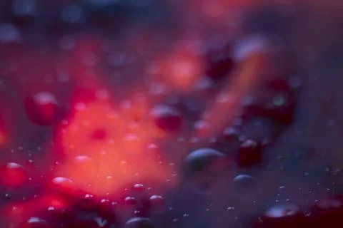 Wet dark glowing abstract background. Blue, purple, and fire colors. Stock Photos