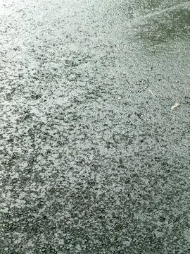 Wet Dark Pavement Surface After Rain with Reflective Texture Stock Photos