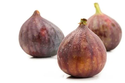 Wet fig in front of two Stock Photos