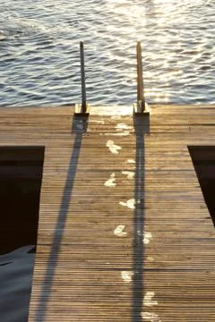 Wet footsteps on dock Stock Photos