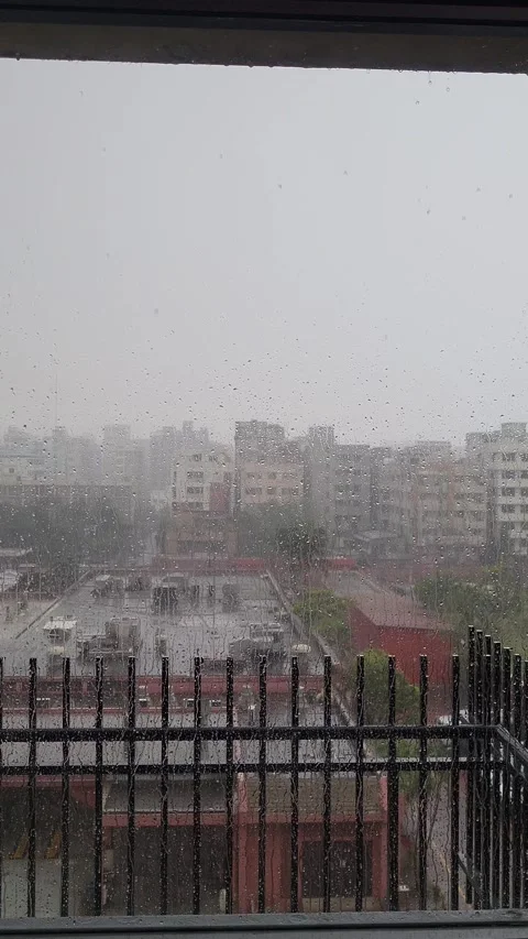 The wet glass of the balcony is rolling down in the heavy rain Stock Footage 286255135