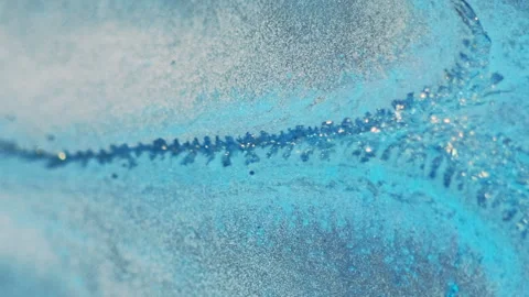 Wet glitter spill ink drip blue metallic paint Video stock 279700559