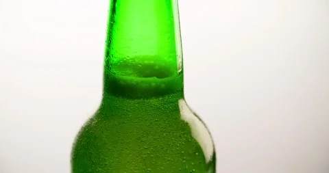 Wet Green Beer Bottle rotating with going up Bubbles Closeup Slow motion Stock Footage 103639968