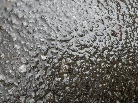 Wet ground surface texture close-up with water droplets and mud after rain,.. 库存照片