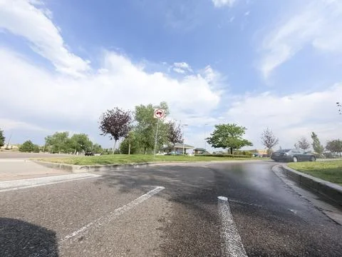 Wet Intersection With Painted Arrows And Grass Median Stock Photos