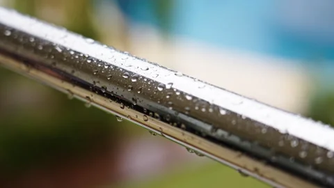 Wet iron railing during rain with a pool are defocused in the background Vídeo Stock 268591375
