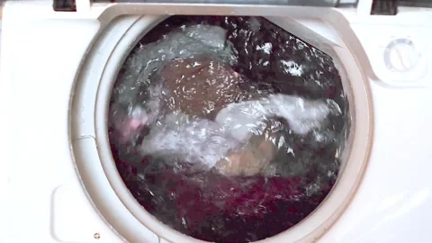 Wet laundry soaking inside a washing machine Stock Footage 321260401