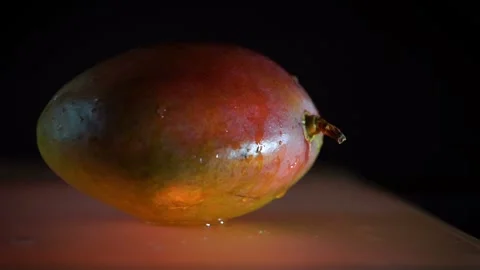 Wet mango with water dripping on it Stock Footage 100885057