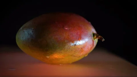 Wet mango with water dripping on it Stock Footage