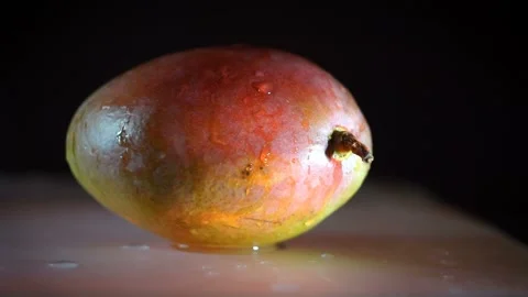 Wet mango with water dripping on it Stock Footage 100885339